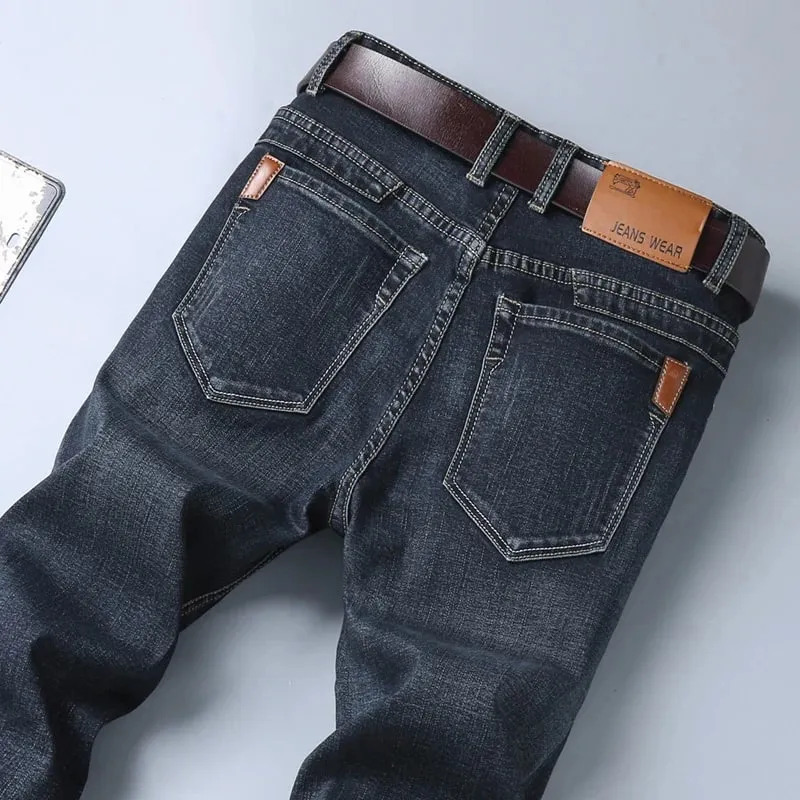 La nueva versión coreana para hombres es suave y cómoda, pantalones vaqueros elásticos de corte Regular, pantalones vaqueros negros de negocios de algodón informales a la moda